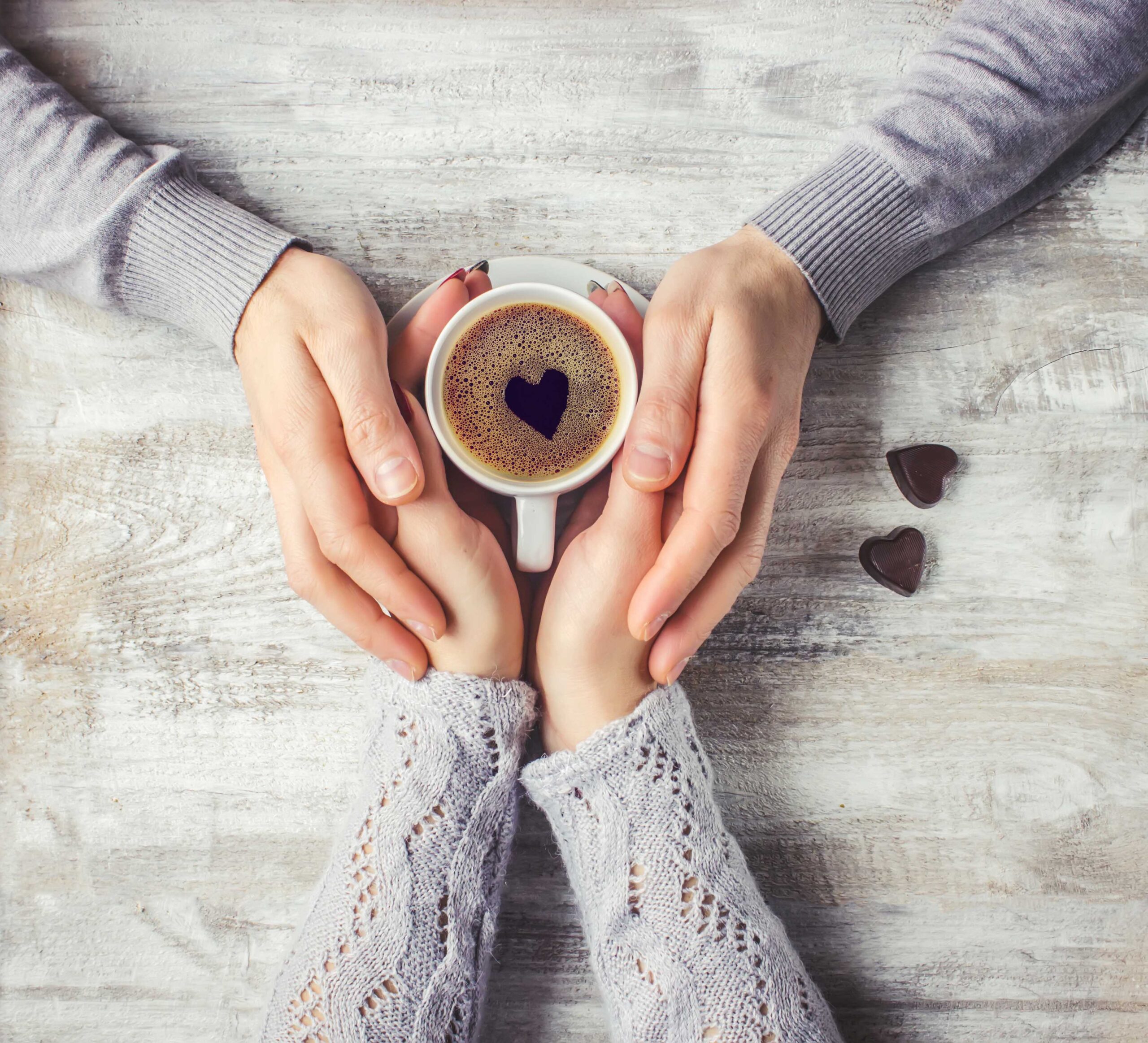 lovers holding together a Cup of coffee. Selective focus.